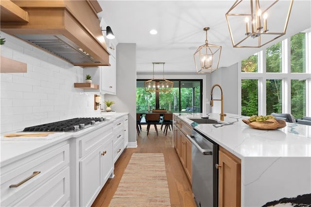 23717 W 118th Ter, Olathe, KS 66061 - kitchen with appliances with stainless steel finishes, custom range hood, a chandelier, open shelves, and decorative backsplash