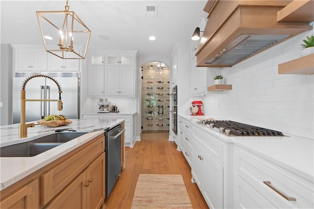 23717 W 118th Ter, Olathe, KS 66061 - kitchen featuring appliances with stainless steel finishes, custom range hood, light countertops, tasteful backsplash, and recessed lighting