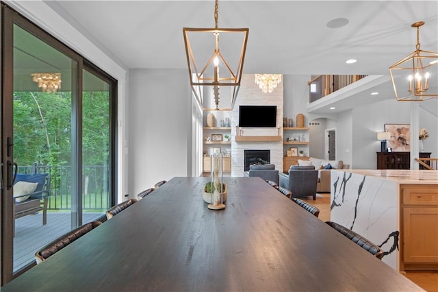 23717 W 118th Ter, Olathe, KS 66061 - dining area featuring a chandelier, a fireplace, light wood finished floors, and recessed lighting
