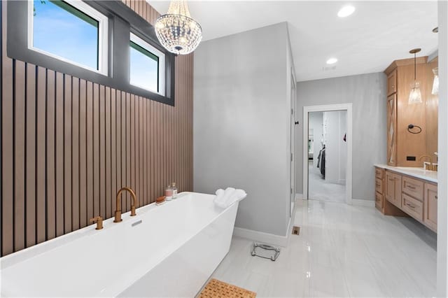 23717 W 118th Ter, Olathe, KS 66061 - full bathroom with a freestanding bath, marble finish flooring, vanity, recessed lighting, and a chandelier