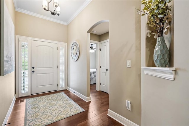 1415 SW Antiquity Dr, Lees Summit, MO 64081 - entrance foyer featuring arched walkways, ornamental molding, and dark wood finished floors