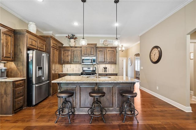 1415 SW Antiquity Dr, Lees Summit, MO 64081 - kitchen with stainless steel appliances, a kitchen breakfast bar, decorative backsplash, an island with sink, and crown molding