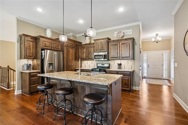 1415 SW Antiquity Dr, Lees Summit, MO 64081 - kitchen featuring appliances with stainless steel finishes, backsplash, recessed lighting, a breakfast bar, and pendant lighting