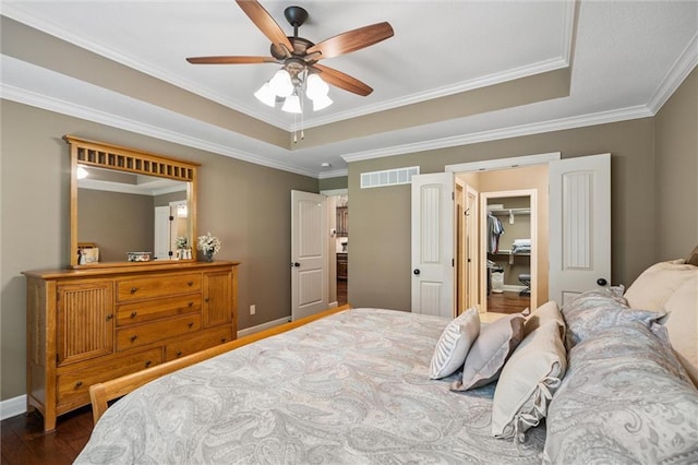 1415 SW Antiquity Dr, Lees Summit, MO 64081 - bedroom with ornamental molding, a tray ceiling, a spacious closet, dark wood finished floors, and ceiling fan