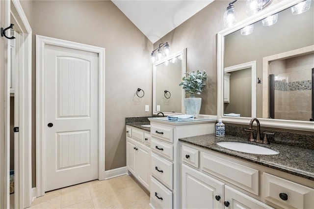 1415 SW Antiquity Dr, Lees Summit, MO 64081 - bathroom with double vanity, vaulted ceiling, a tile shower, and tile patterned flooring