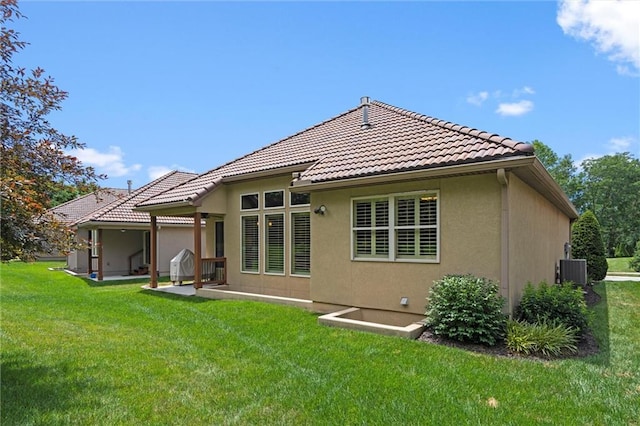 1415 SW Antiquity Dr, Lees Summit, MO 64081 - back of property featuring a yard, stucco siding, and a tiled roof