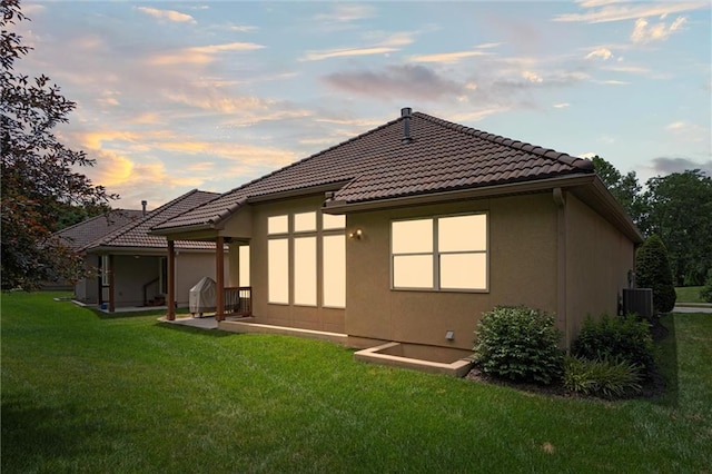 1415 SW Antiquity Dr, Lees Summit, MO 64081 - back of property featuring a lawn, a tile roof, and stucco siding