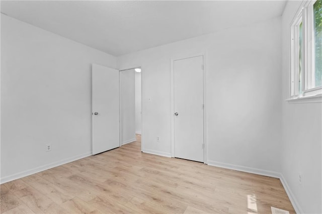 600 W Powahatan Ct, Independence, MO 64056 - unfurnished bedroom with light wood-style flooring