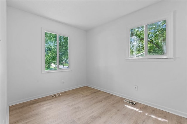600 W Powahatan Ct, Independence, MO 64056 - spare room featuring plenty of natural light and light wood-style flooring