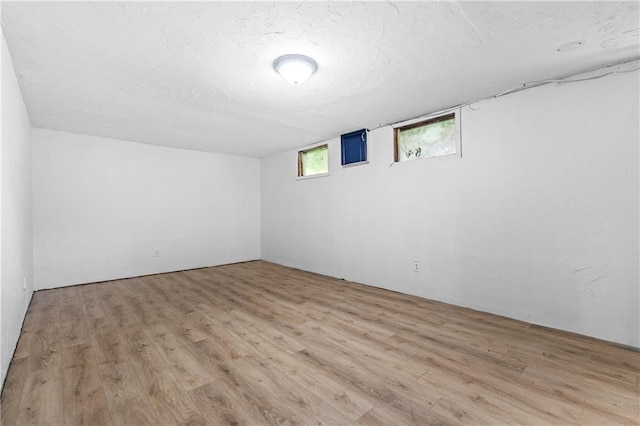 600 W Powahatan Ct, Independence, MO 64056 - below grade area featuring wood finished floors and a textured ceiling