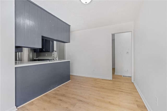 600 W Powahatan Ct, Independence, MO 64056 - kitchen with light wood-type flooring and light countertops