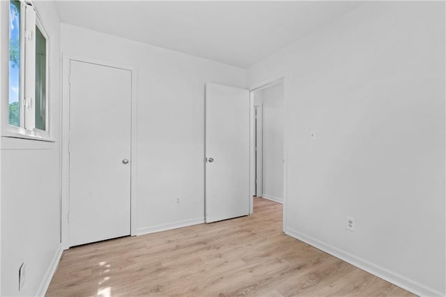 600 W Powahatan Ct, Independence, MO 64056 - unfurnished bedroom with light wood-style flooring and baseboards