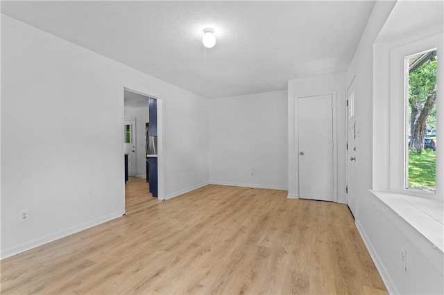 600 W Powahatan Ct, Independence, MO 64056 - spare room featuring light wood-style flooring and baseboards