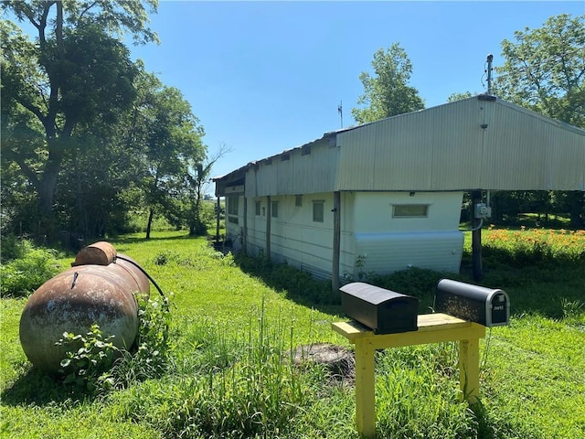 39055 Railroad Ave, Osawatomie, KS 66064 - view of side of home featuring a yard