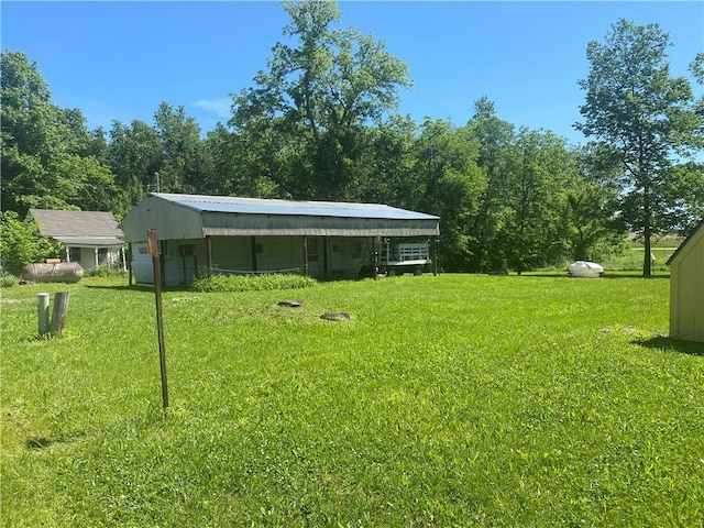 39055 Railroad Ave, Osawatomie, KS 66064 - view of grassy yard with a carport and an outdoor structure