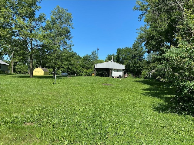 39055 Railroad Ave, Osawatomie, KS 66064 - view of green lawn featuring an outbuilding