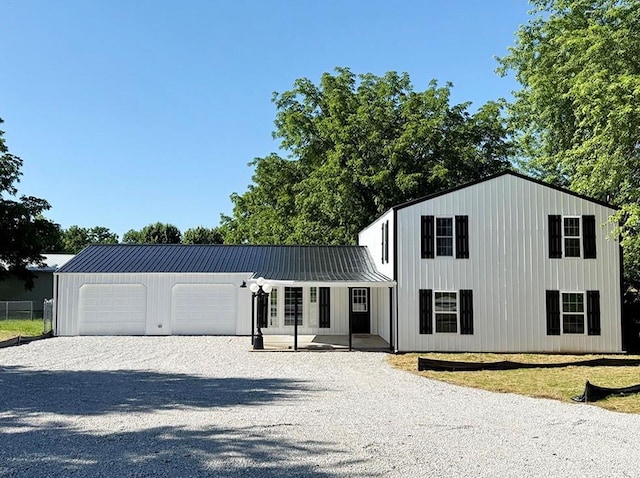 622 Morgan Dr, Stockton, MO 65785 - view of front of home featuring driveway, a metal roof, and an attached garage