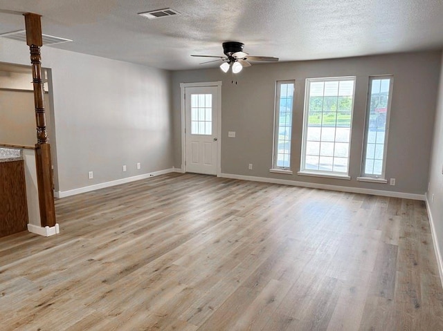 622 Morgan Dr, Stockton, MO 65785 - unfurnished living room featuring a ceiling fan, wood finished floors, and a textured ceiling