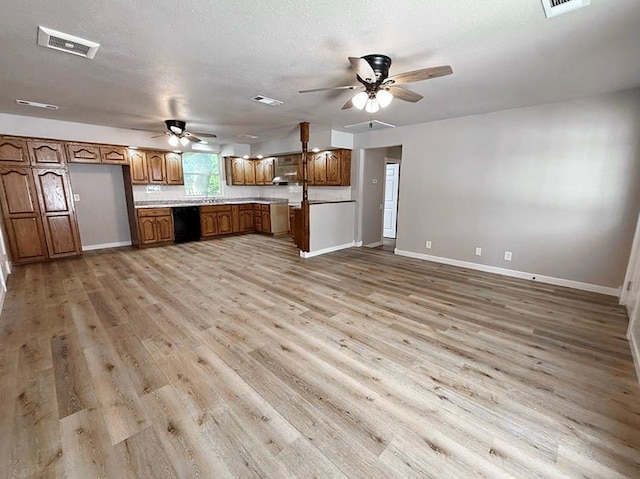 622 Morgan Dr, Stockton, MO 65785 - kitchen with black dishwasher, ceiling fan, brown cabinetry, and light wood-style floors