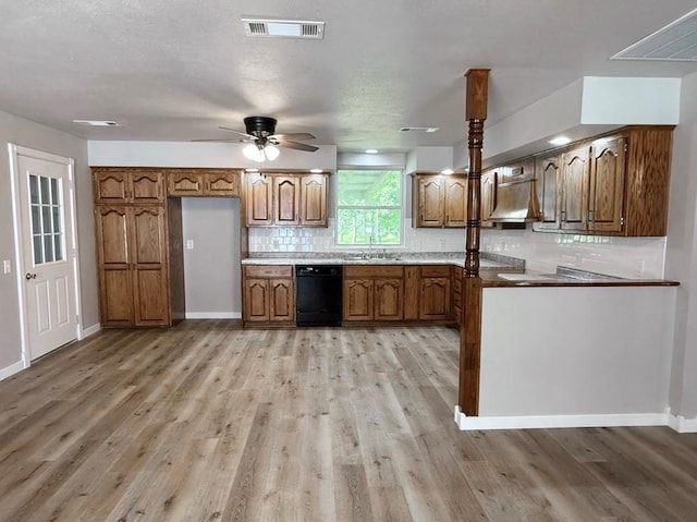 622 Morgan Dr, Stockton, MO 65785 - kitchen featuring black dishwasher, brown cabinets, backsplash, and light wood-style flooring