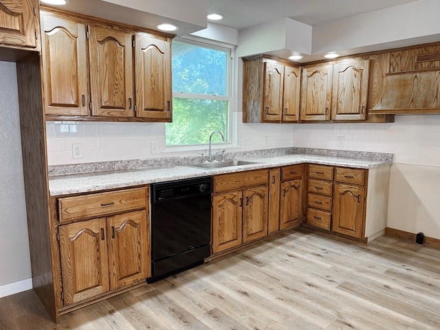 622 Morgan Dr, Stockton, MO 65785 - kitchen featuring black dishwasher, brown cabinetry, tasteful backsplash, light wood-style flooring, and recessed lighting