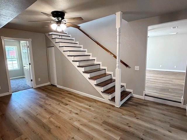 622 Morgan Dr, Stockton, MO 65785 - stairway with wood finished floors, ceiling fan, and a textured ceiling