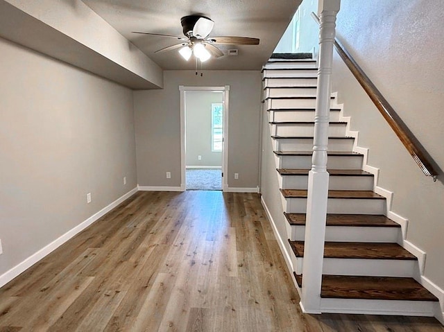 622 Morgan Dr, Stockton, MO 65785 - staircase featuring a ceiling fan and wood finished floors