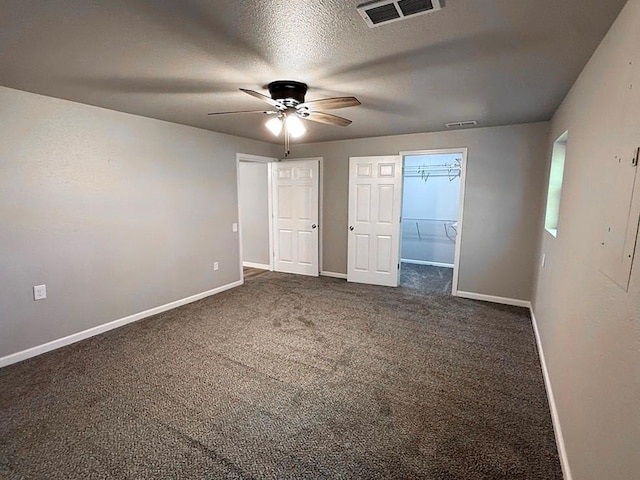 622 Morgan Dr, Stockton, MO 65785 - unfurnished room with ceiling fan, dark colored carpet, and a textured ceiling