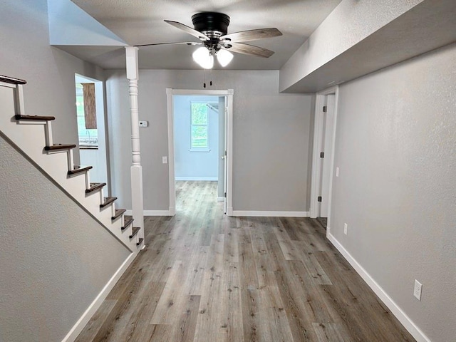 622 Morgan Dr, Stockton, MO 65785 - foyer with wood finished floors, a ceiling fan, stairway, and a textured wall