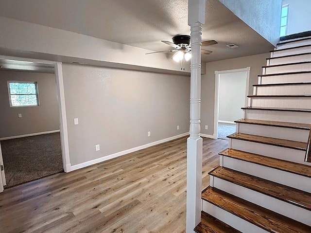 622 Morgan Dr, Stockton, MO 65785 - below grade area with stairs, ceiling fan, and wood finished floors