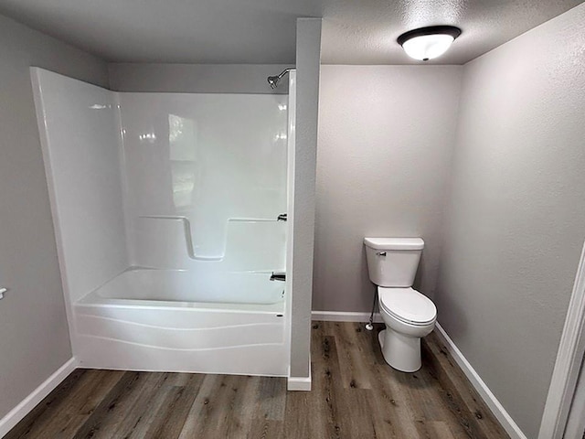 622 Morgan Dr, Stockton, MO 65785 - full bath featuring wood finished floors, tub / shower combination, and a textured ceiling