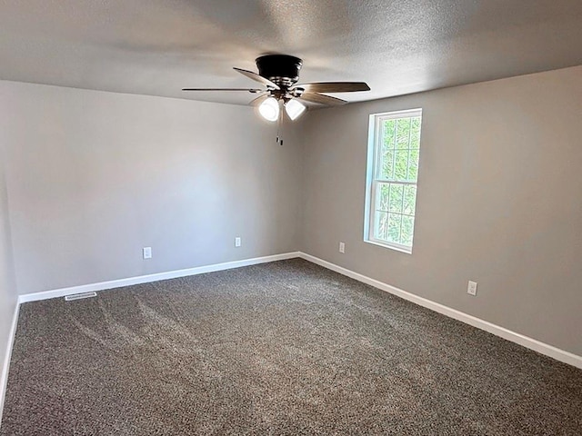 622 Morgan Dr, Stockton, MO 65785 - spare room with ceiling fan, dark carpet, and a textured ceiling