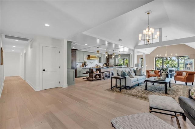 12811 W 71st St, Shawnee, KS 66216 - living area featuring a chandelier, light wood-style floors, recessed lighting, and a towering ceiling