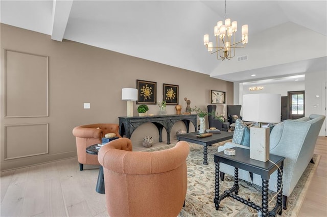 12811 W 71st St, Shawnee, KS 66216 - living room featuring a chandelier, light wood-style flooring, and lofted ceiling