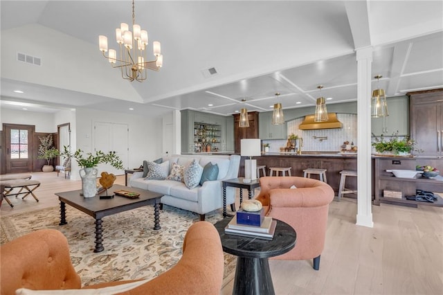 12811 W 71st St, Shawnee, KS 66216 - living area featuring light wood-type flooring, a chandelier, coffered ceiling, recessed lighting, and decorative columns