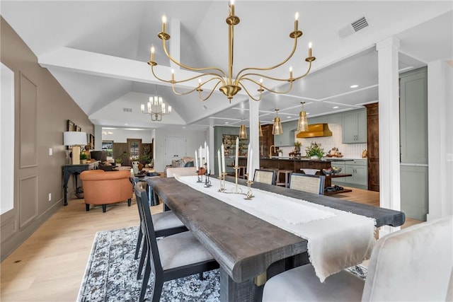 12811 W 71st St, Shawnee, KS 66216 - dining room featuring light wood-style flooring, a chandelier, lofted ceiling, and recessed lighting