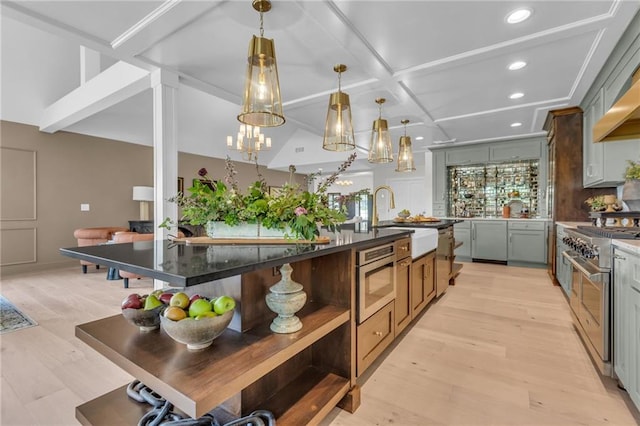 12811 W 71st St, Shawnee, KS 66216 - kitchen with appliances with stainless steel finishes, recessed lighting, an island with sink, a chandelier, and open shelves