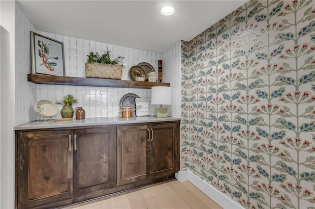 12811 W 71st St, Shawnee, KS 66216 - bar with light wood-style flooring and tasteful backsplash