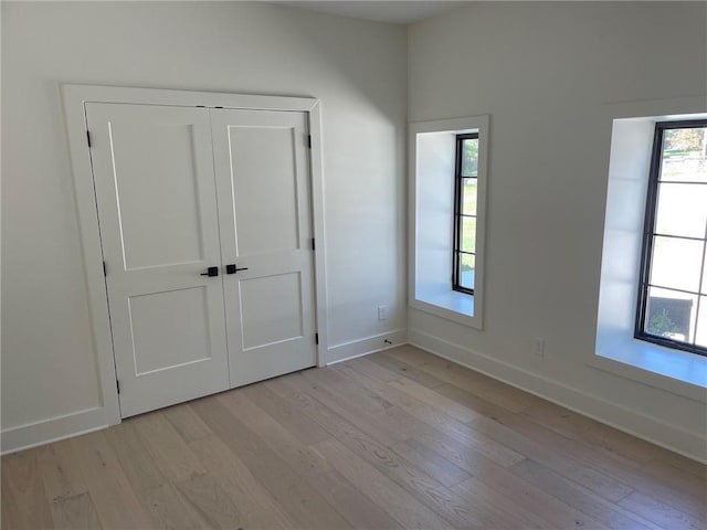 12811 W 71st St, Shawnee, KS 66216 - unfurnished bedroom with light wood-type flooring and a closet