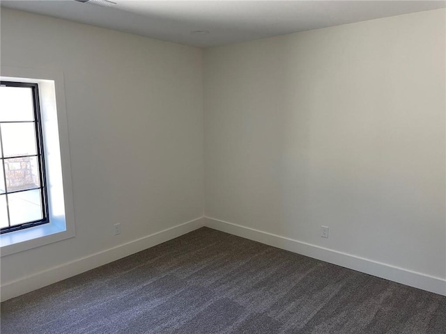 12811 W 71st St, Shawnee, KS 66216 - empty room featuring dark carpet and baseboards