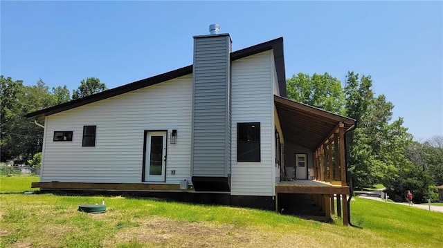 104 Lakeshore Dr, Kimberling City, MO 65686 - rear view of property featuring a yard and a chimney