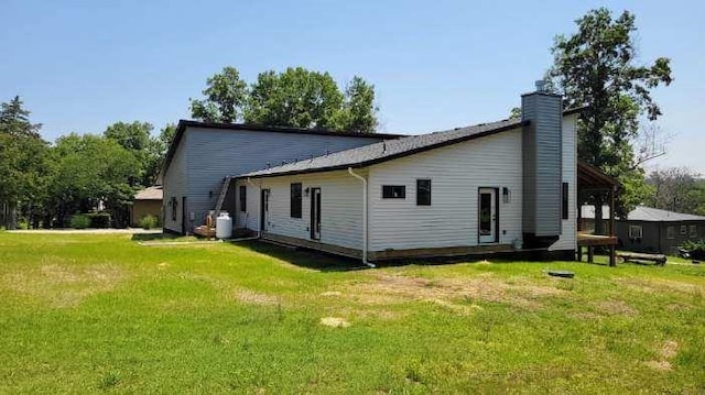 104 Lakeshore Dr, Kimberling City, MO 65686 - back of property with a lawn and a chimney