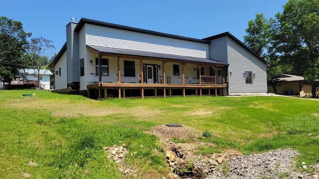 104 Lakeshore Dr, Kimberling City, MO 65686 - rear view of house with a chimney and a lawn