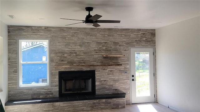 104 Lakeshore Dr, Kimberling City, MO 65686 - unfurnished living room with ceiling fan, a fireplace with raised hearth, and plenty of natural light