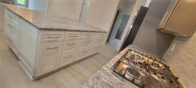 104 Lakeshore Dr, Kimberling City, MO 65686 - kitchen with white cabinetry, light stone counters, and light wood-type flooring
