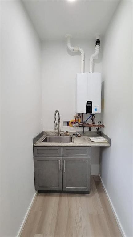 104 Lakeshore Dr, Kimberling City, MO 65686 - bar area with tankless water heater and light wood-style flooring