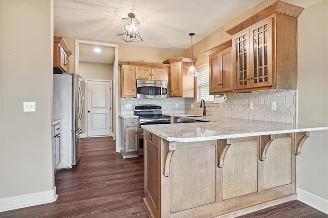 5214 NE 70th St, Kansas City, MO 64199 - kitchen featuring stainless steel appliances, a peninsula, dark wood-style flooring, glass insert cabinets, and tasteful backsplash