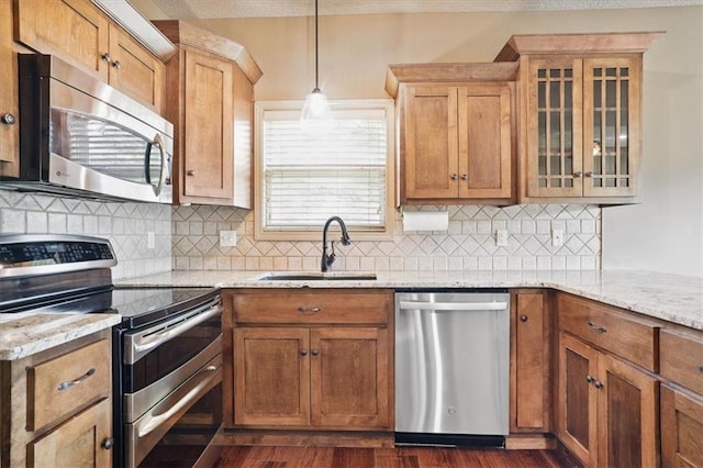 5214 NE 70th St, Kansas City, MO 64199 - kitchen with stainless steel appliances, tasteful backsplash, glass insert cabinets, and light stone counters