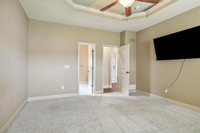 5214 NE 70th St, Kansas City, MO 64199 - unfurnished bedroom with a raised ceiling, carpet flooring, and a ceiling fan