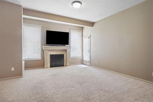 5214 NE 70th St, Kansas City, MO 64199 - unfurnished living room featuring a textured ceiling, carpet flooring, and a fireplace with flush hearth